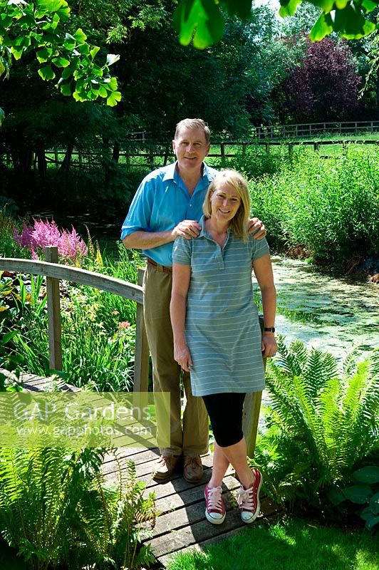 Portrait of owners David and Clodagh Dugdale standing on a wooden bridge