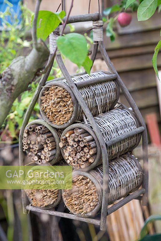 An upcycled wicker wine rack used for Insect houses