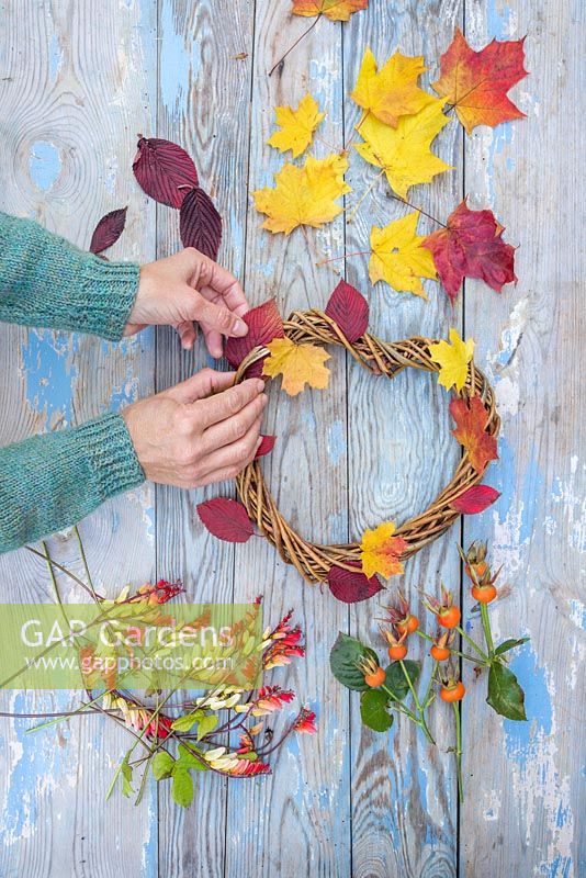 Weaving autumnal leaves into the woven heart wreath