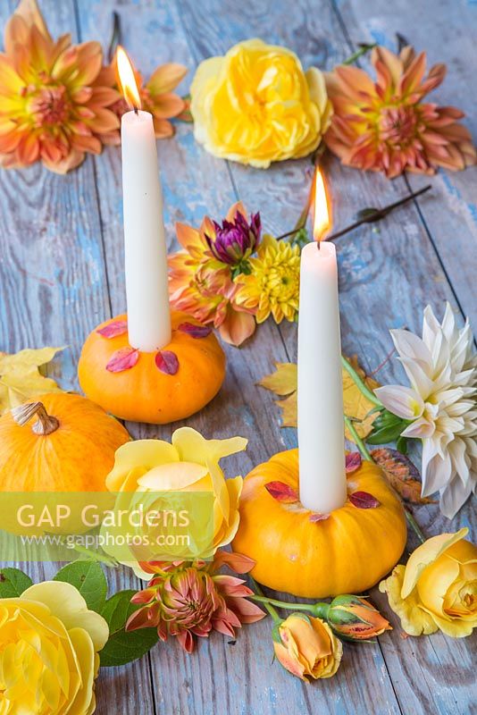 Small gourds used as candle holders accompanied with nasturtium flowers