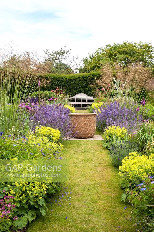 Double herbaceous borders leading to seating