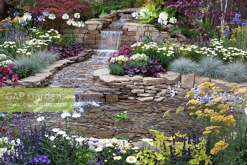 The pond and waterfall in the centre of 'The Water Garden' at RHS Tatton Flower Show 2015