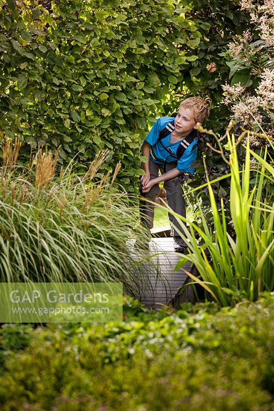 Boy investigating the walled garden. Marks Hall Gardens and Arboretum