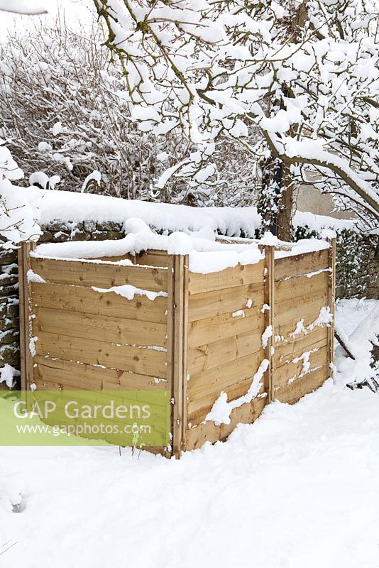 Wooden compost bins in snow