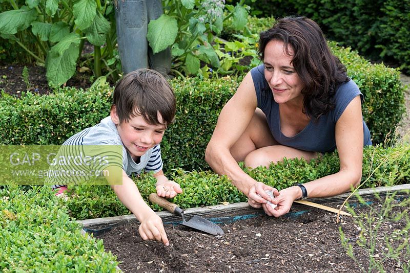 Dawn Isaac gardening with her 8 year old son, Oscar.