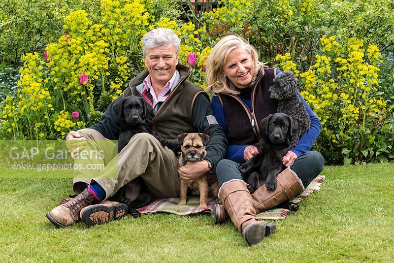 Mike and Annie Johnson, owners of Alswick Hall, with Ivy, a Highland terrier, and Twiglet, a miniature poodle, and 7-month-old black labrador puppies, Snowdrop and Daphne.