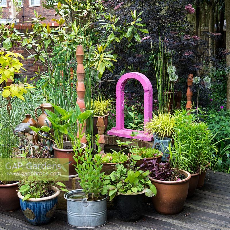 A painted window frame, a quirky focal point in the centre of a small contemporary town garden.