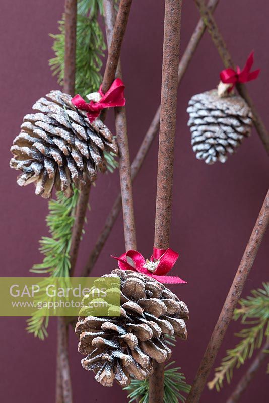 Pine cones with red ribbons used as hanging decorations
