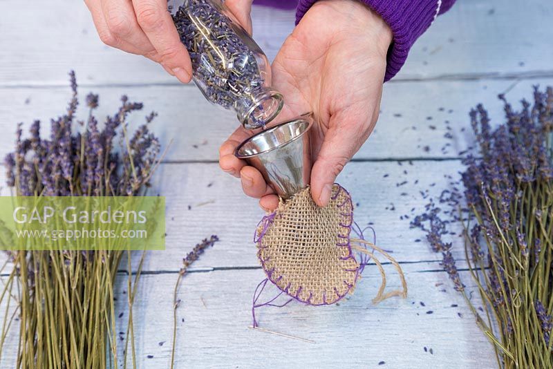 Use a funnel to assist with filling the hessian heart with the dried Lavender flowers