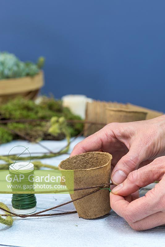 Use the florist wire to secure the Peat free fibre pots to the wreath frame