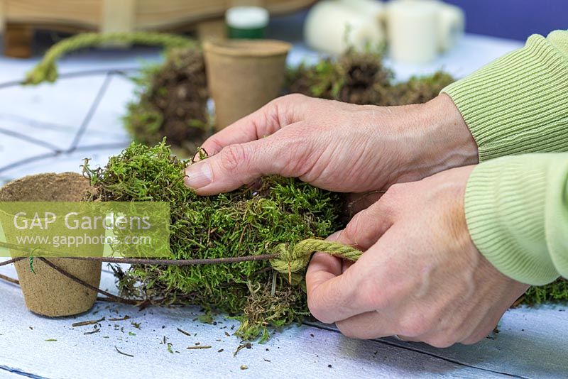 Pad out the wreath frame with moss, making sure the green side is facing outwards