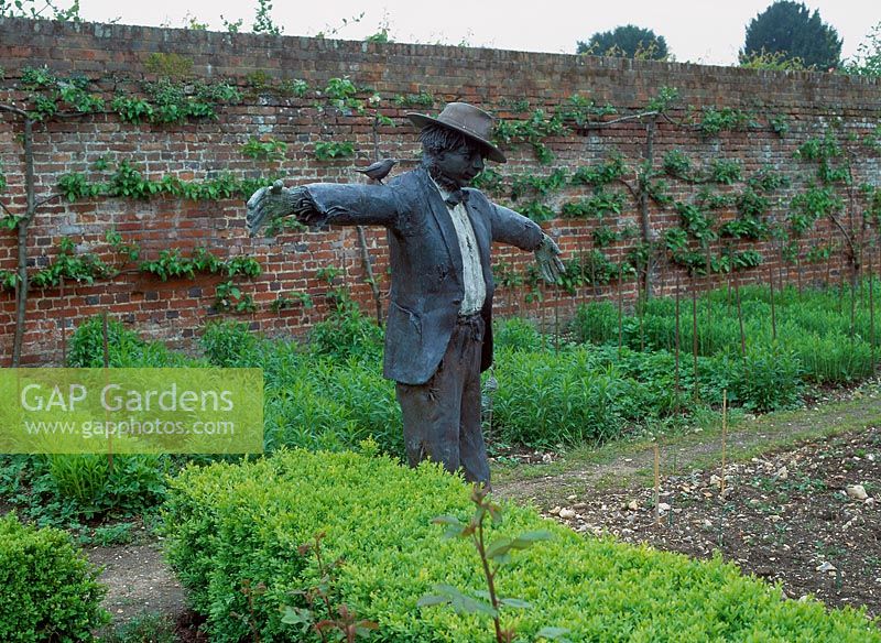 Scarecrow statue in vegetable garden. Godmersham Park. Owner: John Sunley