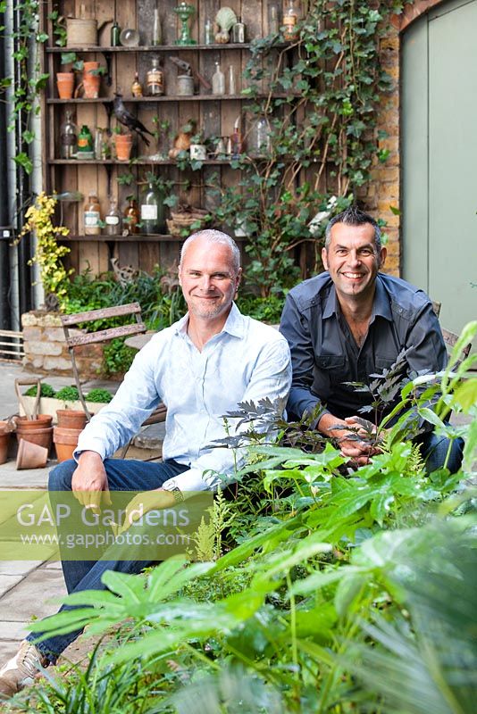 Portrait of Adam Woolcott and Jonathan Smith in Lucille Lewins, small courtyard garden, London. Designed by Adam Woolcott and Jonathan Smith 