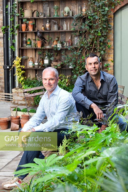 Portrait of Adam Woolcott and Jonathan Smith in Lucille Lewins, small courtyard garden, London. Designed by Adam Woolcott and Jonathan Smith