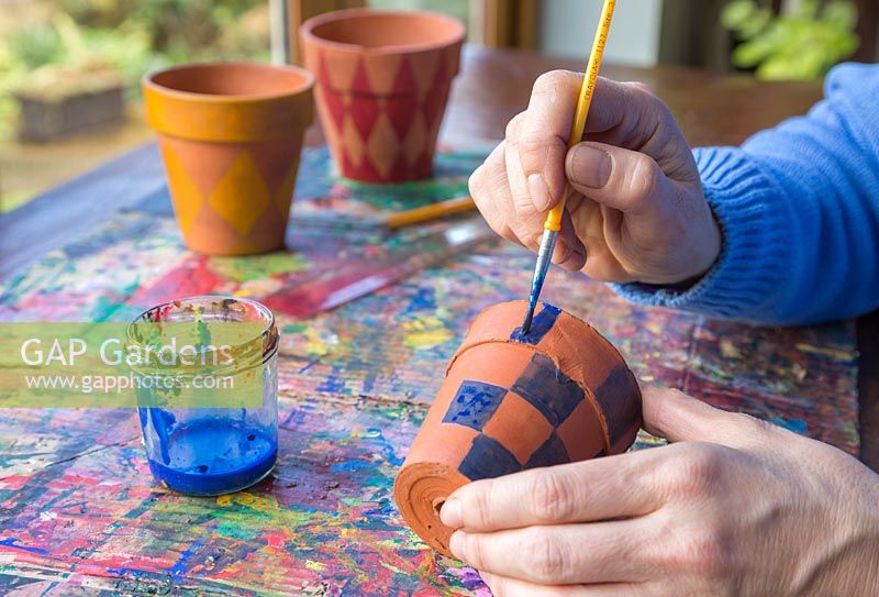 Paint the pots in a chequered formation to recreate the tartan pattern