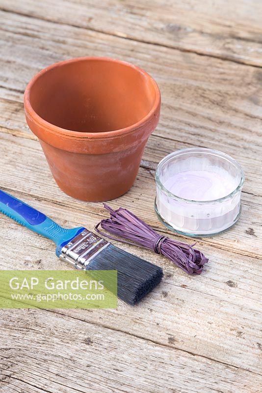 Materials required are a paintbrush, coloured raffia, terracotta pot and whitewash or lime paint