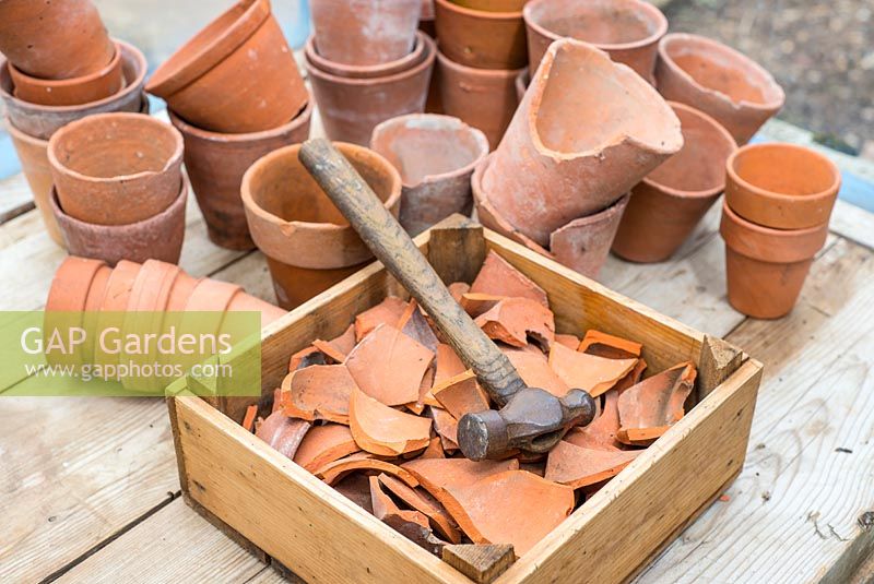 Terracotta crocks with crock hammer and terracotta flower pots