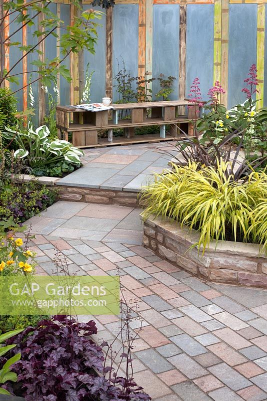 Seating area and paving path with raised borders in the 'Garden for All Ages' at BBC Gardener's World Live 2015