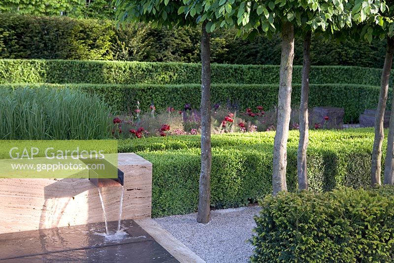 Hedging around modern water feature. The Laurent-Perrier Garden Design: Luciano Giubbilei Gold Medal winner, RHS Chelsea Flower Show 2009. Contemporary water feature, box hedging, formal hornbeam