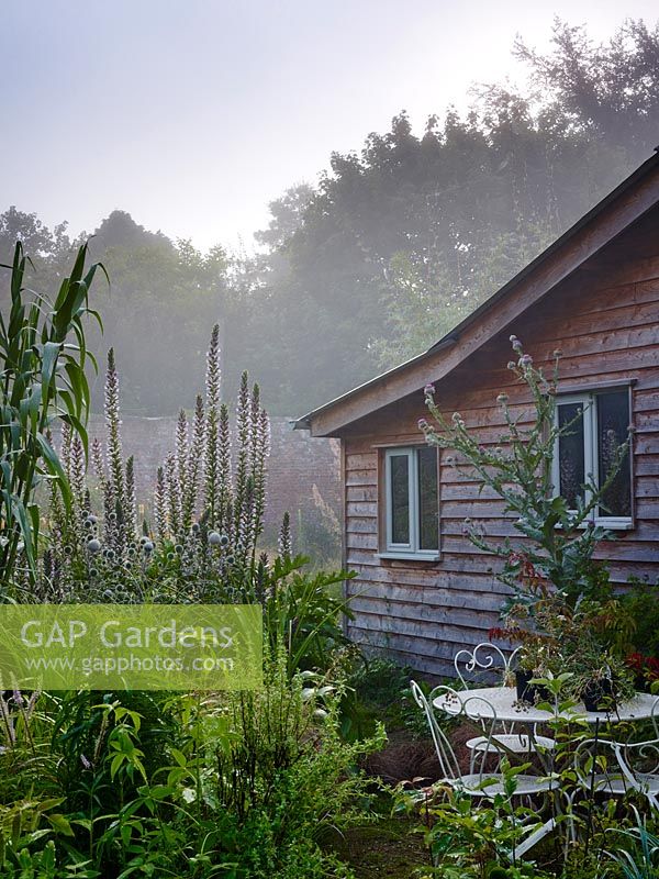 The sales hut backs on to the garden with plants such as acanthus, echinops and arundo donax