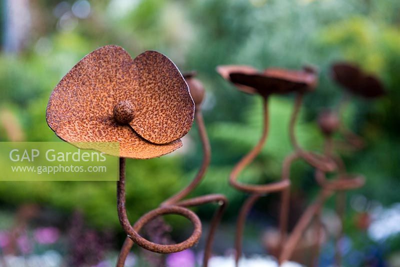 Rusted steel sculpture - closeup detail of a poppy. 