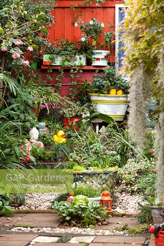 A collection of retro cement pots and quirky garden ornaments.