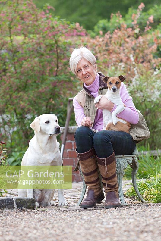 Roz Los, the garden owner, with Jinx the Jack Russell and Jazz the Labrador. Ellerker House, Everingham, Yorkshire. Spring, March 2016.