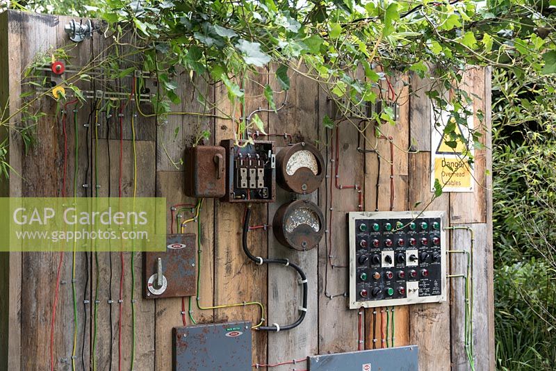Plants growing through disused electrical switchboard - Frankensteins Nature, Designers: Anca Panait and Greg Mekle, Festival International des Jardins 2016, Domaine de Chaumont sur Loire, France