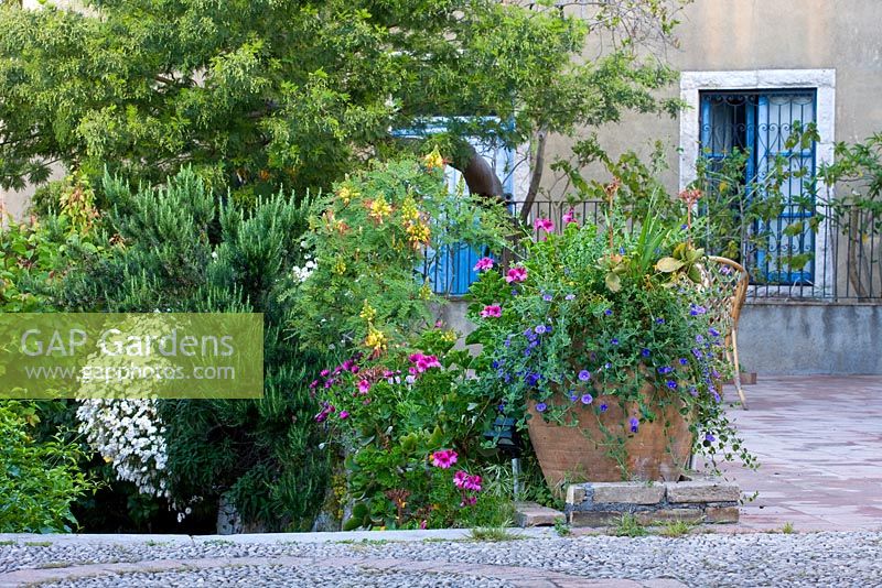 Patio with terracotta container. Casa Cuseni in Taormina, Sicily, Italy