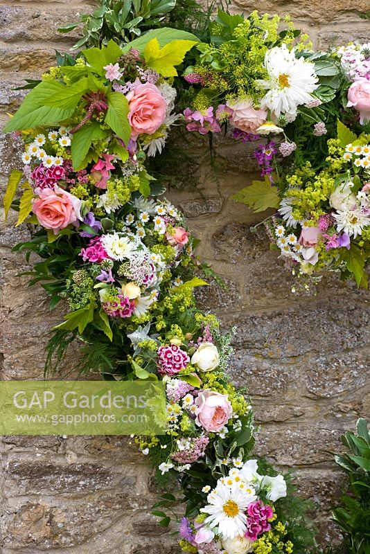 Floral wreath made from fresh flowers picked from the garden - roses, sweet william and golden hop. Common Farm Flowers, Somerset

