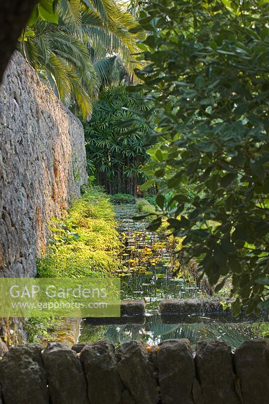 A cascading stone waterway feeds water drawn from a deep well into the arabic garden. San Giuliano Estate. Sicily, Italy