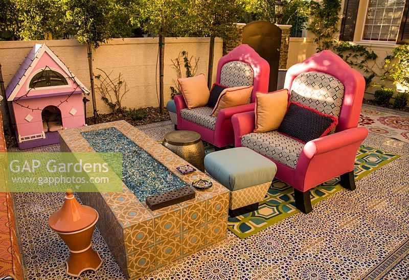 Patio with decorative tiled surface and quirky furniture