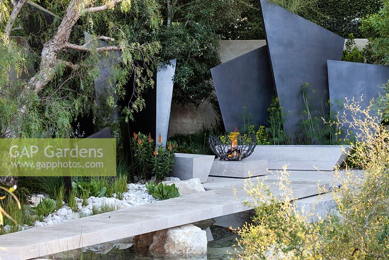 The Telegraph Garden featuring dramatic bronze fins, representing an ancient mountain range, bordered by Isoplexis Canariensis, Ridolfia segetum and Schinus Molle  - Designer: Andy Sturgeon - RHS Chelsea Flower Show, 2016.