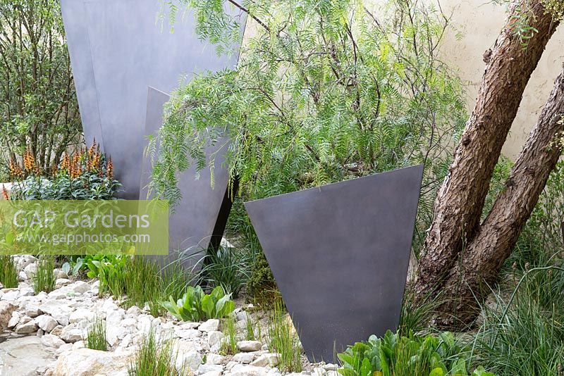 The Telegraph Garden, adobe wall, bronze coated fin panel screens, Isoplexis canariensis. RHS Chelsea Flower Show 2016. Designer: Andy Sturgeon - Sponsor: The Telegraph