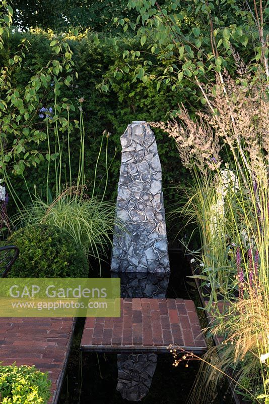 Reflecting pool with brick stepping stone and flint sculpture - Streetscape's Summer in Sussex, RHS Hampton Court Palace Flower Show 2016