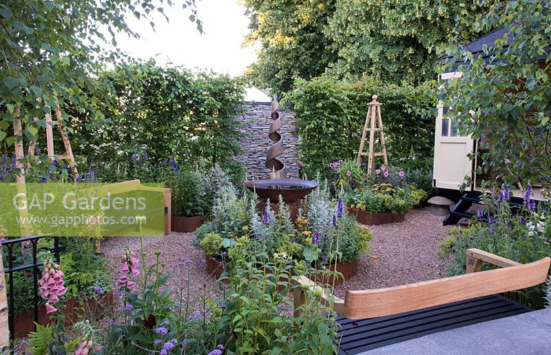 Simon Thomas Pirie Floating Benches around a rustic effect water bowl  - CCLA: A Summer Retreat, Design: Amanda Waring and Laura Arison, RHS Hampton Court Palace Flower Show 2016.