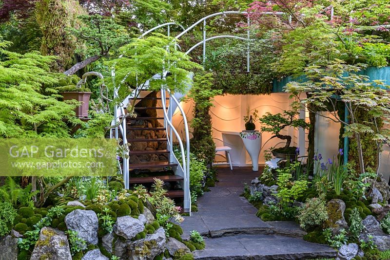 Senri Sentei - Garage Garden, a space to relax surrounded by a curved staircase with a white banister, leading to roof garden. The RHS Chelsea Flower Show 2016. Designer: Kazuyuki Ishihara - Sponsor: Senri-Sentei Project - GOLD