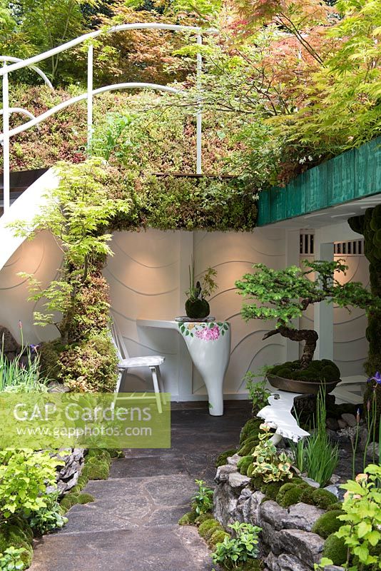 Seating area under stairs leading to a green roof - Senri-Sentei-Garage Garden, RHS Chelsea Flower Show 2016, Designer: Kazyuki Ishihara, Sponsor: Senri-Sentei Project