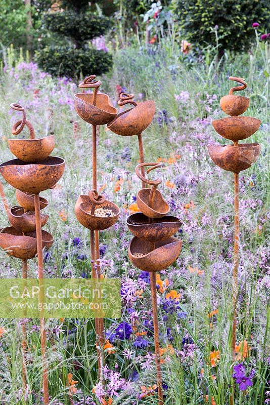 Rusty metal birdseed cups by Moore Designs - Greening Grey Britain Garden, RHS Chelsea Flower Show 2016, Design: Ann-Marie Powell