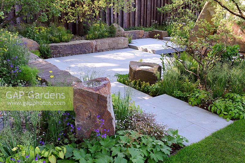 The M and G Garden. Large stone seats and bird bath rocks in sunken terrace. RHS Chelsea Flower Show, 2016 Designer: Cleve West MSGD, Sponsor: M and G 