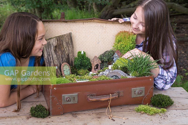 Two girls happy with their completed miniature garden project