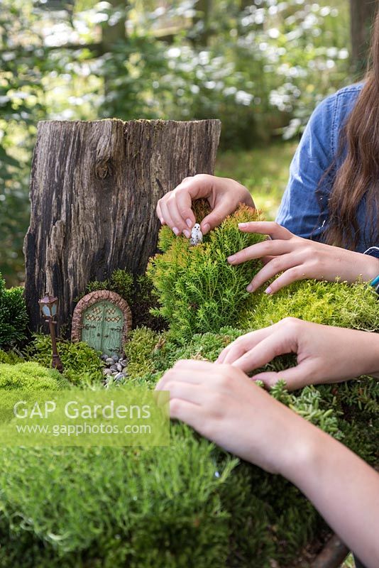 Miniature Wheelbarrow Garden. Adding animal figurines to the miniature garden