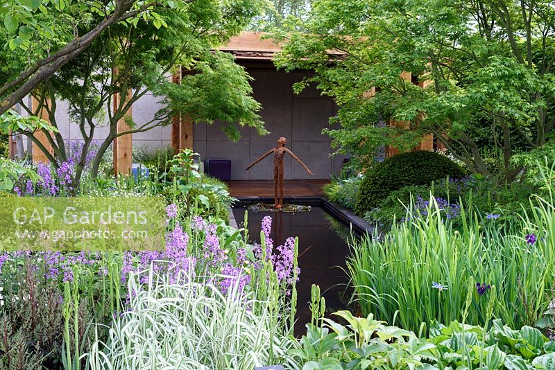 The Morgan Stanley garden for Great Ormond Street Hospital. Shaded woodland garden with water feature and japanese style summer house. RHS Chelsea Flower Show 2016, Designer: Chris Beardshaw, Sponsors: Morgan Stanley
