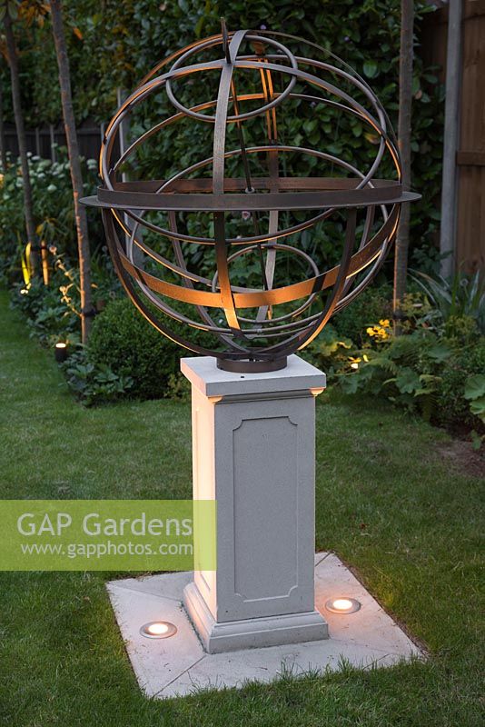 A personalised sundial by David Harber with uplight lighting.