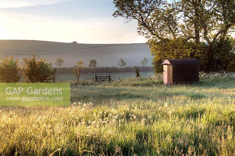 A Shepherds hut in the field adjacent to the garden at Manor Farm