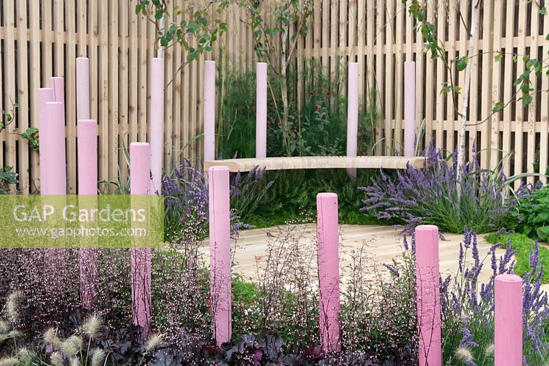 Pink painted wooden posts and attached seat giving a floating effect. Hidden Message, RHS Tatton Flower Show 2011, Cheshire