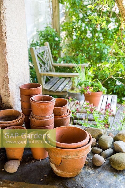 Collection of old terracotta pots and pebbles.
