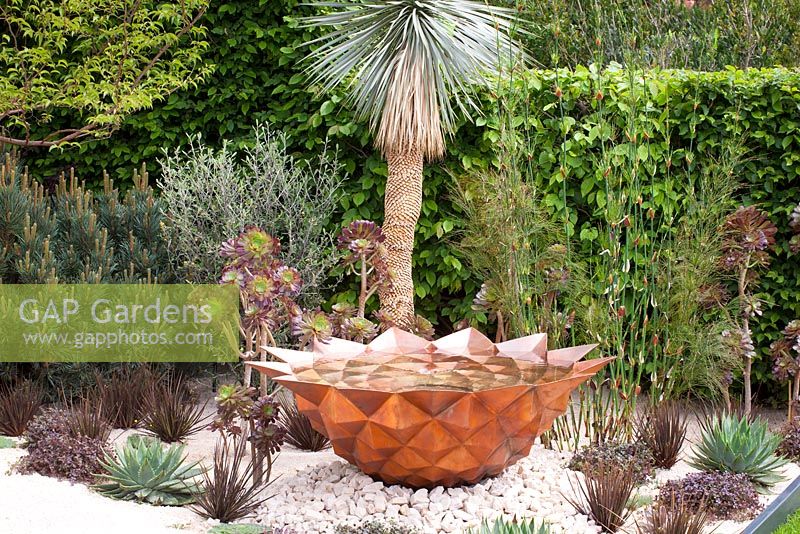 Copper bowl water feature emulating the mathematically perfect Fibonacci spiral in the Winton Beauty of Mathematics Garden, RHS Chelsea Flower Show 2016