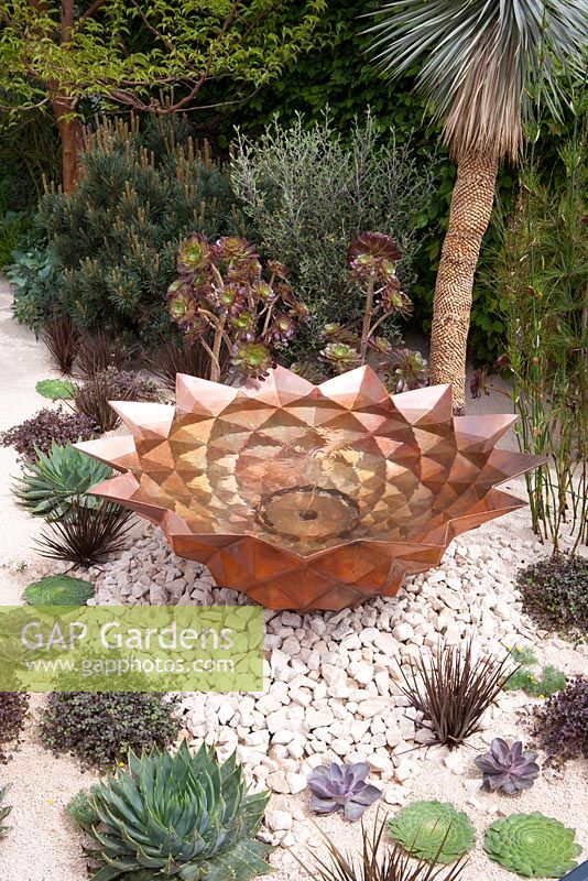 Copper bowl water feature emulating the mathematically perfect Fibonacci spiral in the Winton Beauty of Mathematics Garden, RHS Chelsea Flower Show 2016