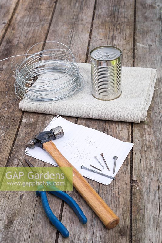 Materials required are some wire cutters, hammer, nails, sketch patterns, wire and a tin can